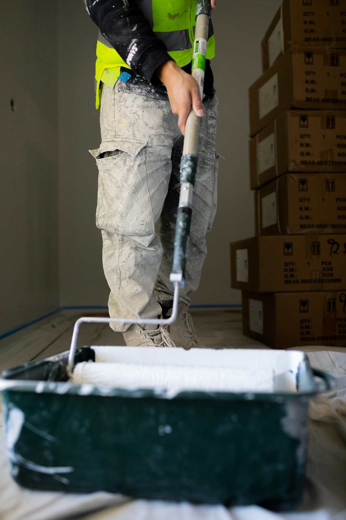 Rolling fresh paint onto a wall